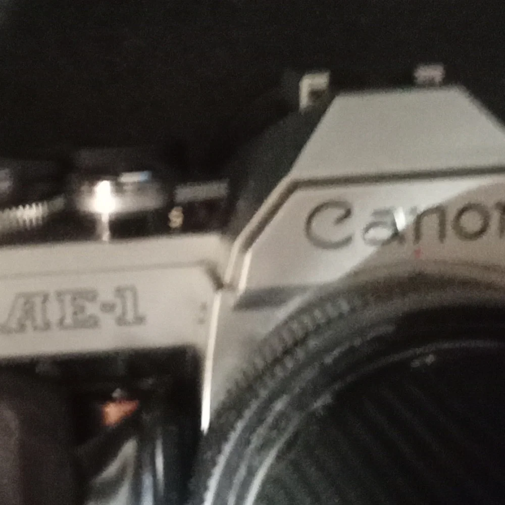 Canon AE1 Black and Silver SLR Camera with Pentax Flash and zoom lens